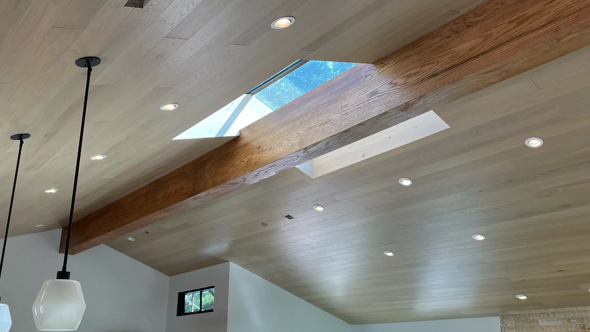 Finished cathedral ceiling with skylight and beam